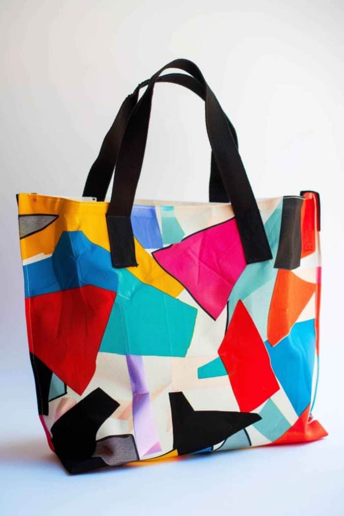 Bold, overlapping blocks of color form an eye-catching pattern on the tote, with black lines and sharply contrasting colors that give it a modern edge.