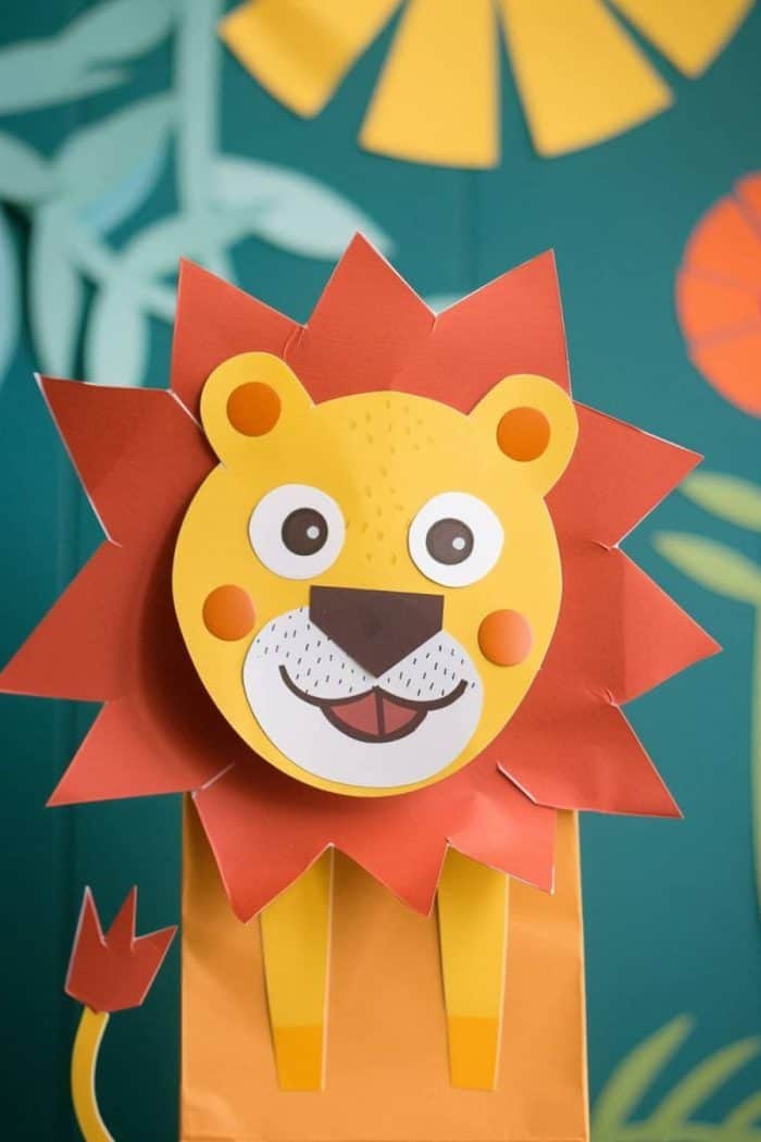 This cheery paper bag lion has a glorious red mane cut out from construction paper that frames its friendly smile.