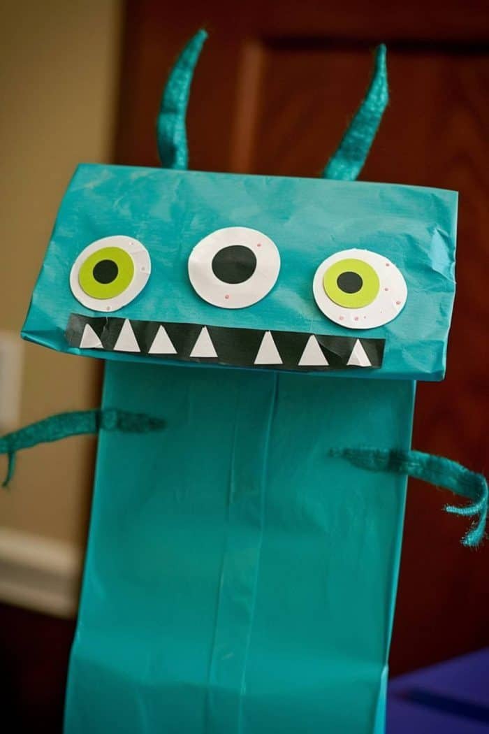 Made from green construction paper, this alien has three whimsical eyes that seem keen to explore our world.