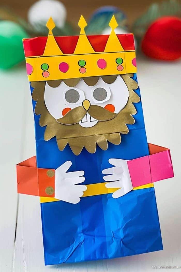 Behold His Majesty, the king! With his drawn-on red robe and his golden paper crown adorned with colorful paper gems, he commands respect and authority.