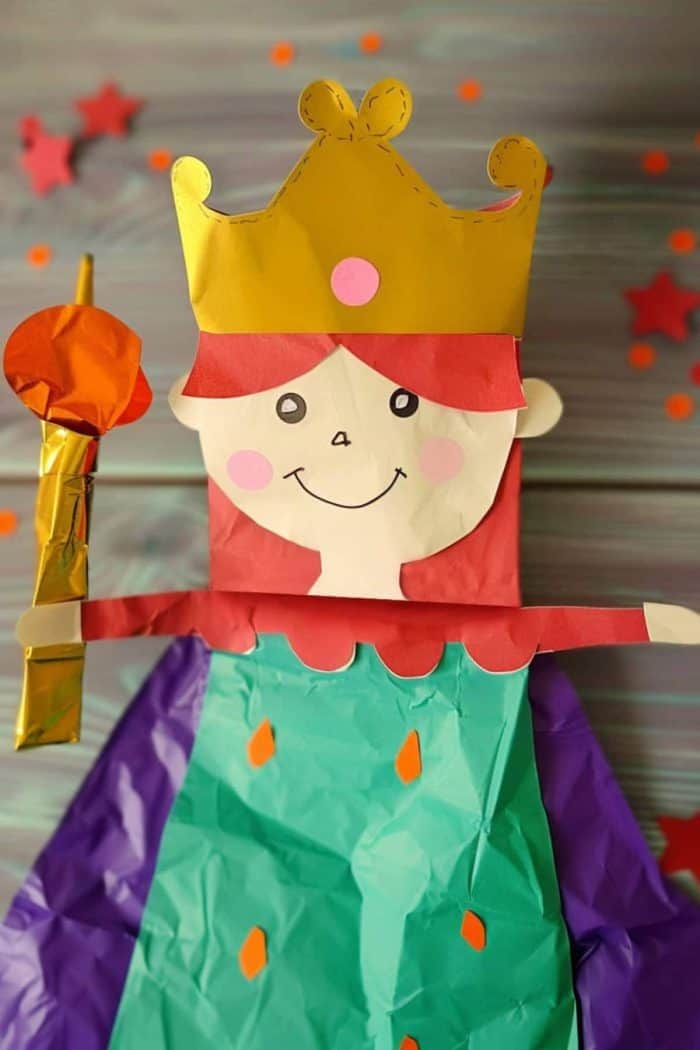 Holding a scepter made of a toothpick, this noble paper bag queen craft looks majestic, especially with her glittery crown that’s studded with colorful paper jewels.