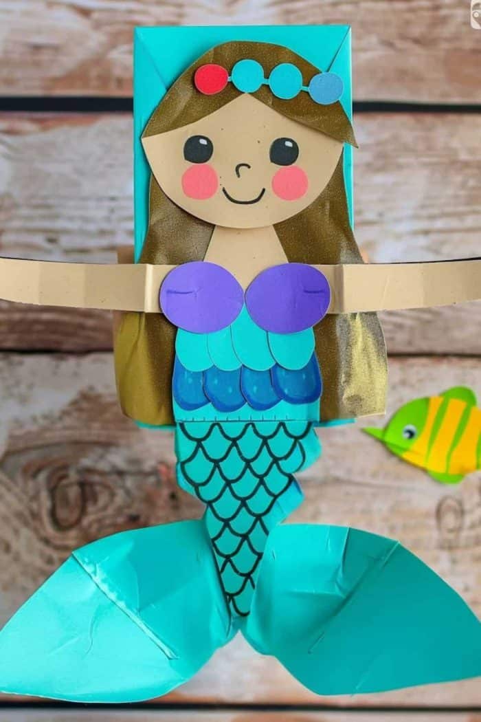 Explore deep-sea tales with this mermaid, an enchanting creature with a blue tail featuring black-lined scales. This underwater character can be further embellished with a multicolored crown.
