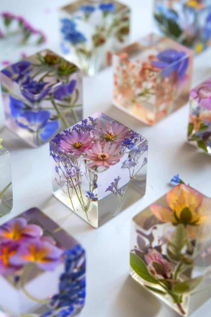 Create paperweights by embedding pressed flowers in clear resin blocks.