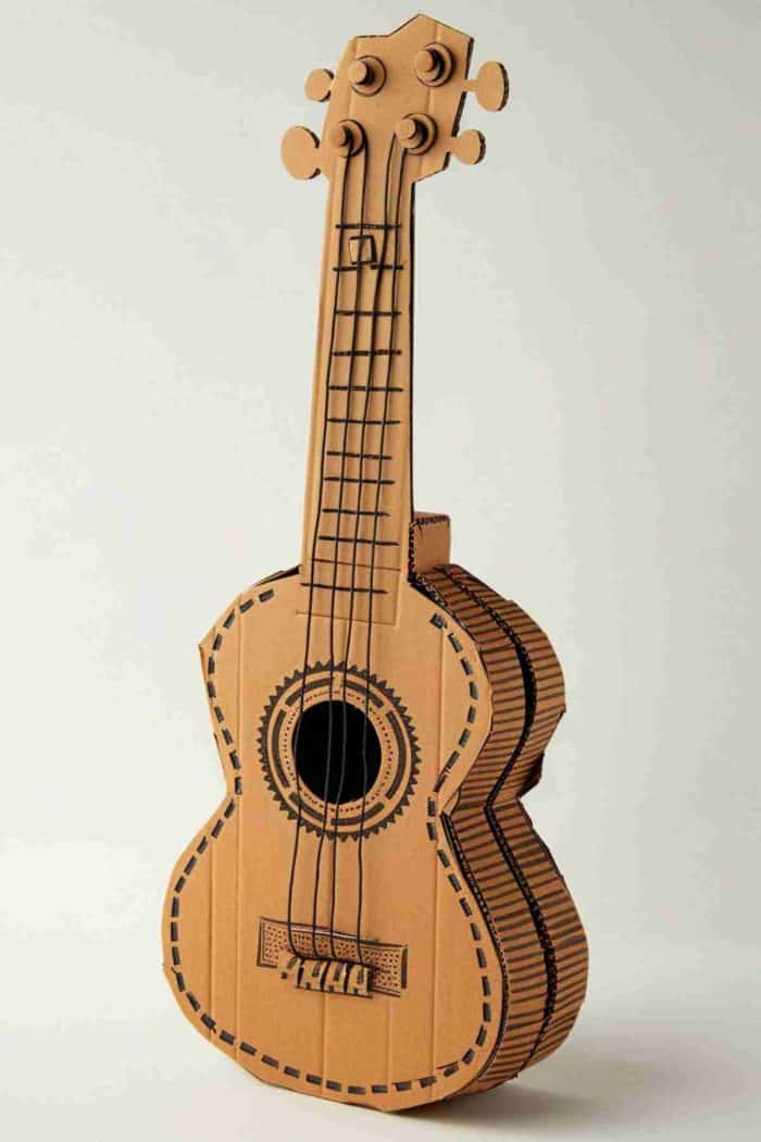 Create cardboard guitars with cut-out centers and drawn-on strings, perfect for pretend play. Decorate with music-themed artwork and attach a paper headstock with tuning peg illustrations to complete the rockstar look.