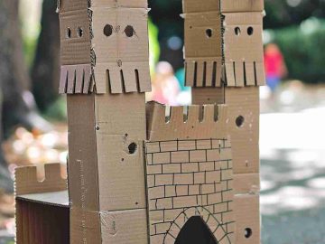 Make a simple cardboard castle with square turrets and cut the top edges to resemble crenellations. 