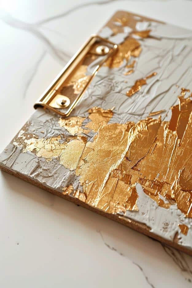 Apply gold leaf to a clipboard for a touch of luxury. The delicate material can be used to highlight edges or create patterns.