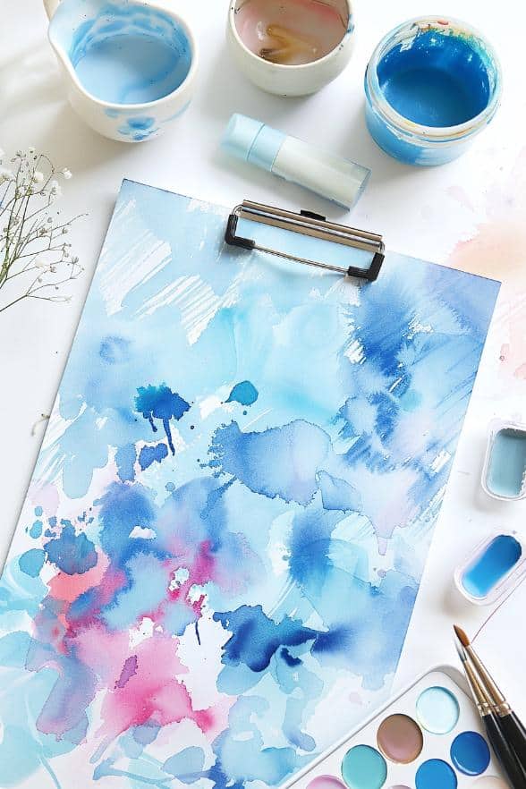 Transform a clipboard into a tranquil canvas with strokes of watercolor paint.