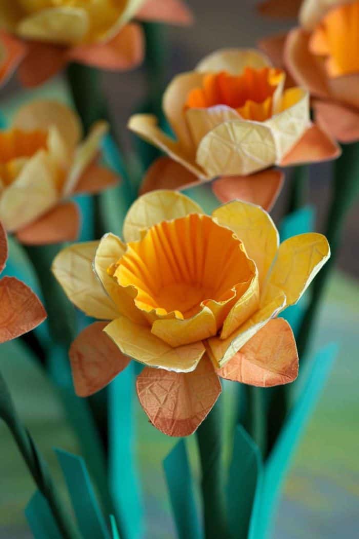 Shape egg carton cups into daffodils, using shades of yellow and orange paint to mimic the gradient of a sunrise. 