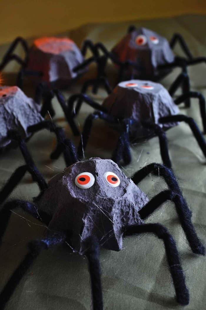 Create spiders by painting egg carton sections in dark colors and adding eight bendable legs from black pipe cleaners. 