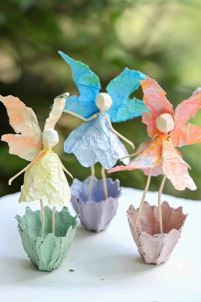Use the rounded bottoms of egg carton cups to cut out flowers and fairy bodies, painting them in light, ethereal colors. 