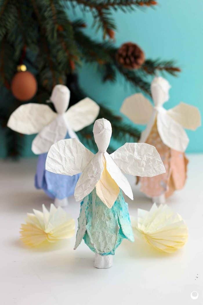 Craft angels by painting egg carton cups white for the body, and attach large, fan-shaped paper wings. Create halos from metallic pipe cleaners or gold paper, affixing them above the angels' heads.