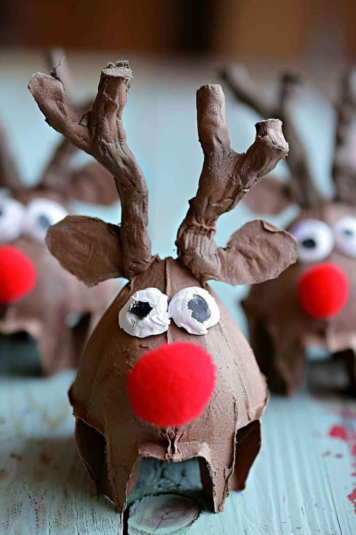 Create reindeer by cutting and shaping egg carton sections for the head and body, painting them in natural brown tones. 