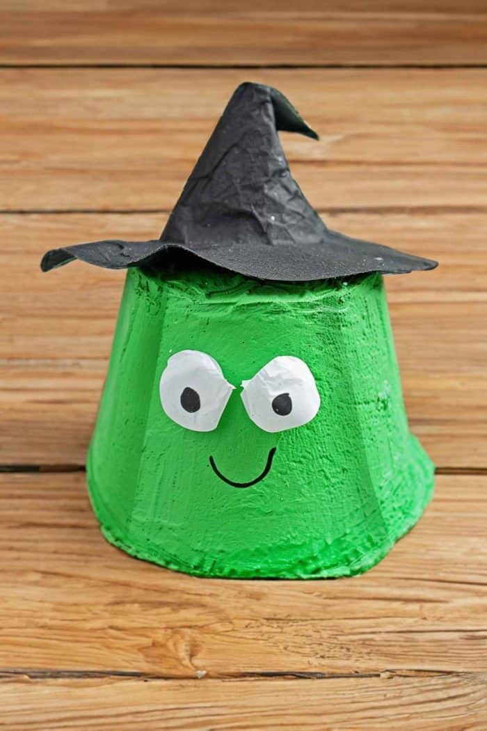 Create a witch’s face by painting egg carton cups green and adding eyes and a mischievous smile. Then add pointy hats from construction paper.