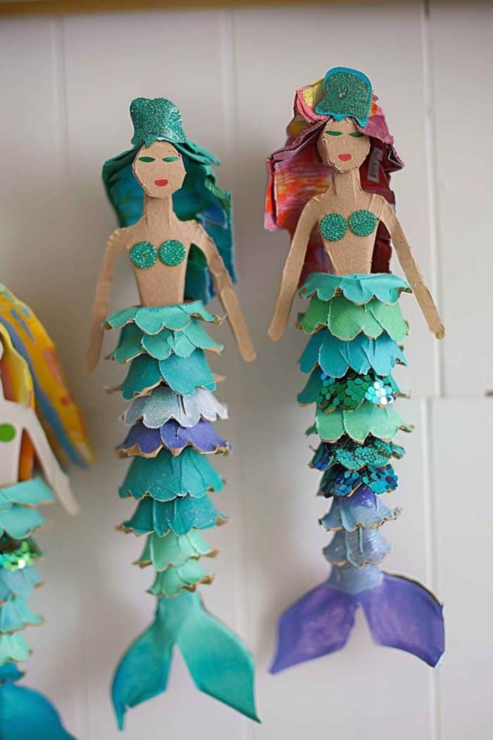 Fashion mermaids by cutting out their scaled tails from the edges of egg carton cups and their bodies from cardboard. Decorate with sequins and small beads to emulate the shimmering effect of scales.