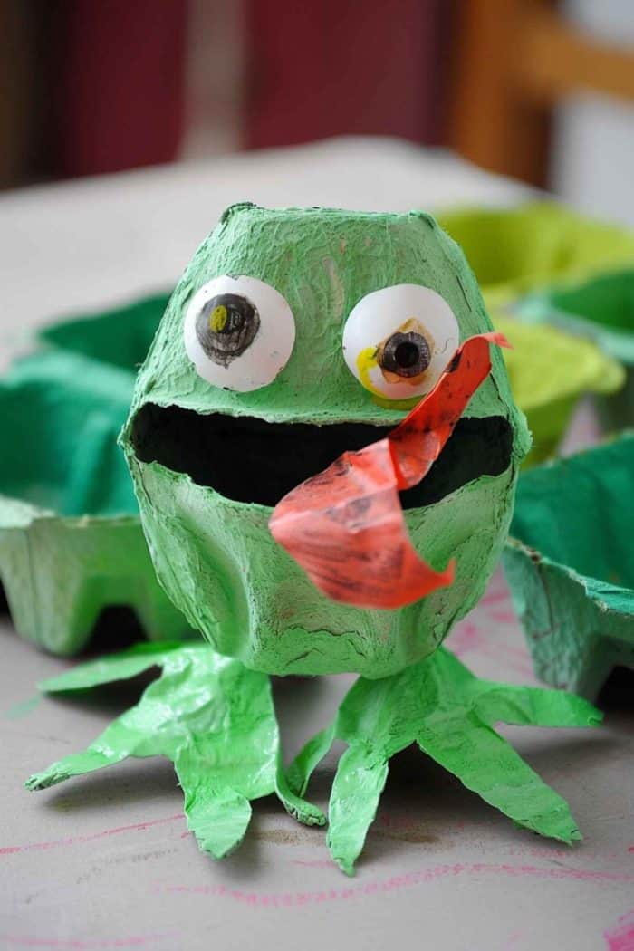 Use egg carton cups as the base for frogs, painting them in various shades of green. Attach oversized googly eyes to the top edge of each cup, and cut hind legs from green paper to complete the playful look.