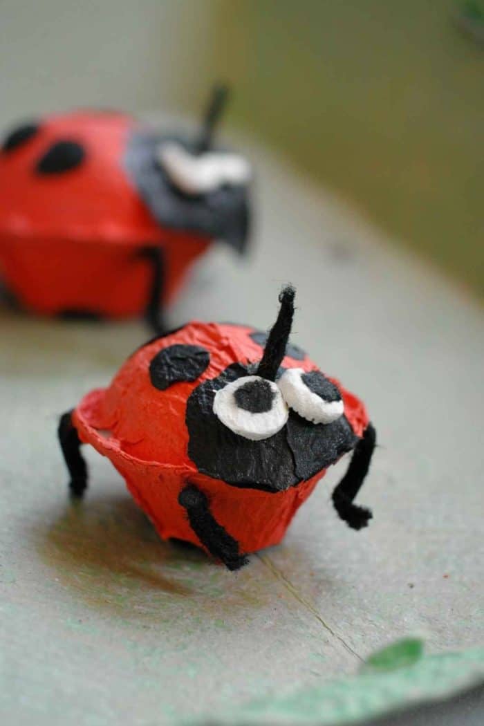 Paint egg carton cups red and add black spots to create ladybugs. Use small black pom-poms for the head and attach tiny googly eyes, ensuring each ladybug has a distinctive pattern of spots.