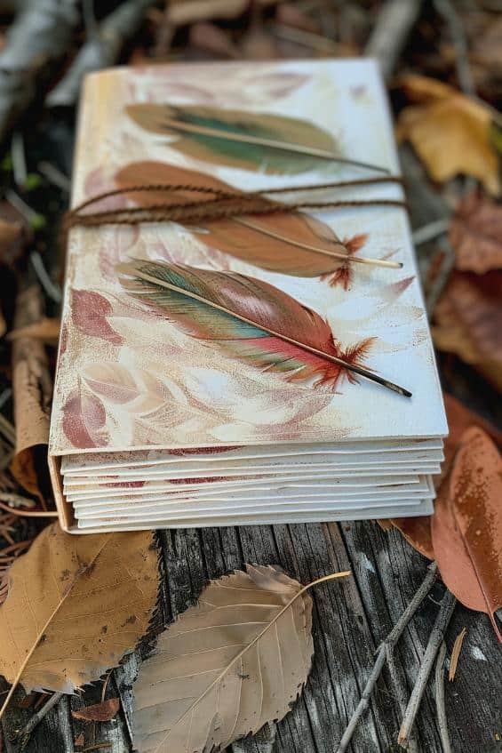 Paste feathers to a journal or diary cover to create a unique and tactile writing experience.