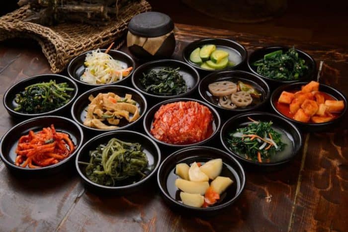 Various Korean Home-style Side Dishes scattered on a small black bowls