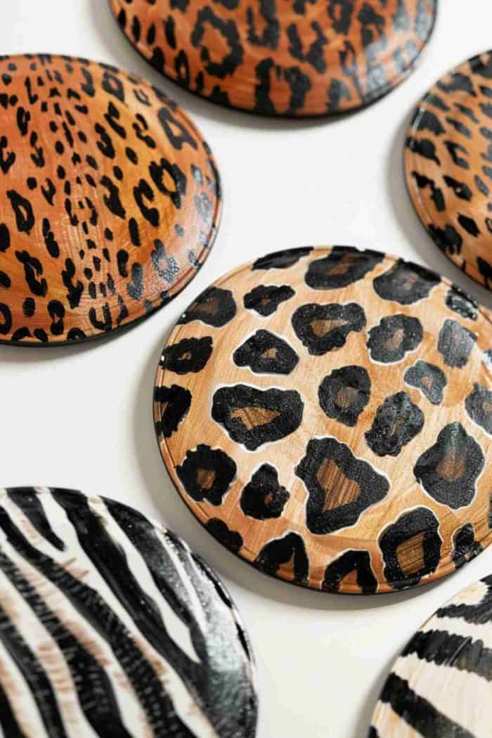 Capture the wild essence of the savannah with coasters painted in zebra stripes and leopard spots. These animal print designs can add a bold and exotic touch to any room's decor.