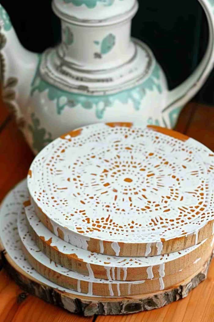 Use stencils to paint intricate lace doily patterns onto coasters, infusing them with a delicate, vintage feel. These coasters can add a touch of nostalgic elegance to any gathering.