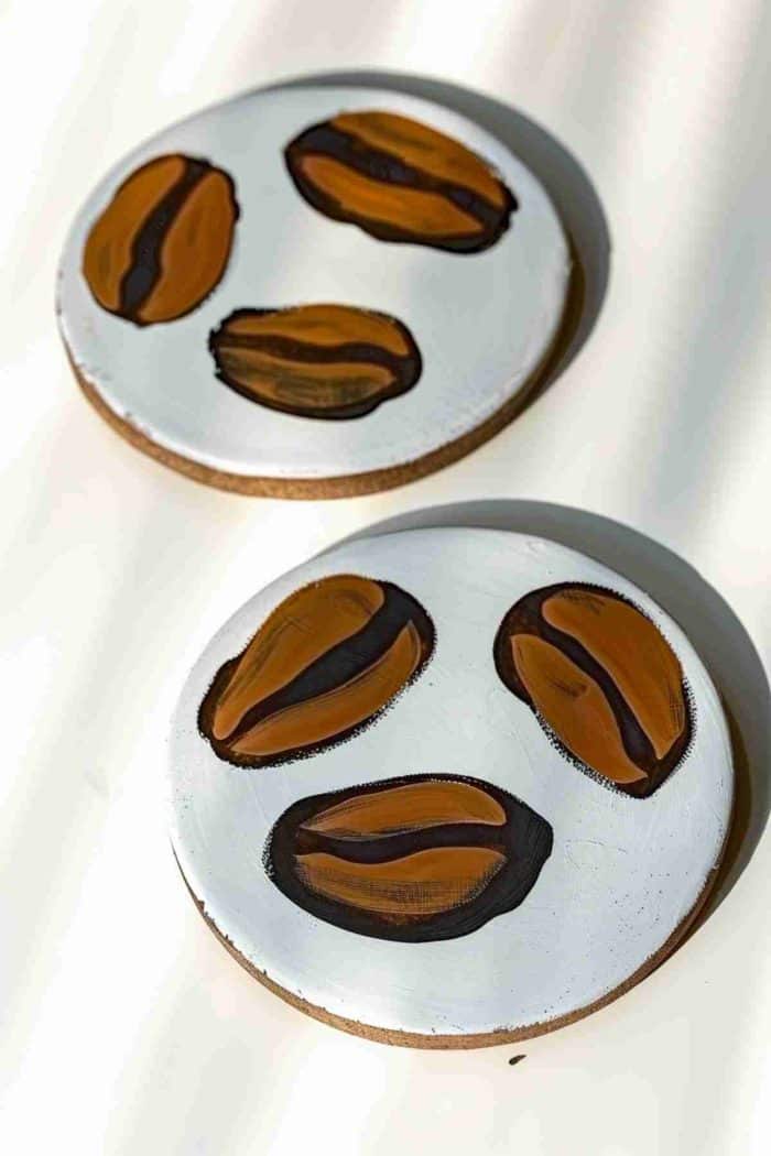 Paint realistic coffee beans on coasters, making them the ideal accessory for coffee tables and morning routines.