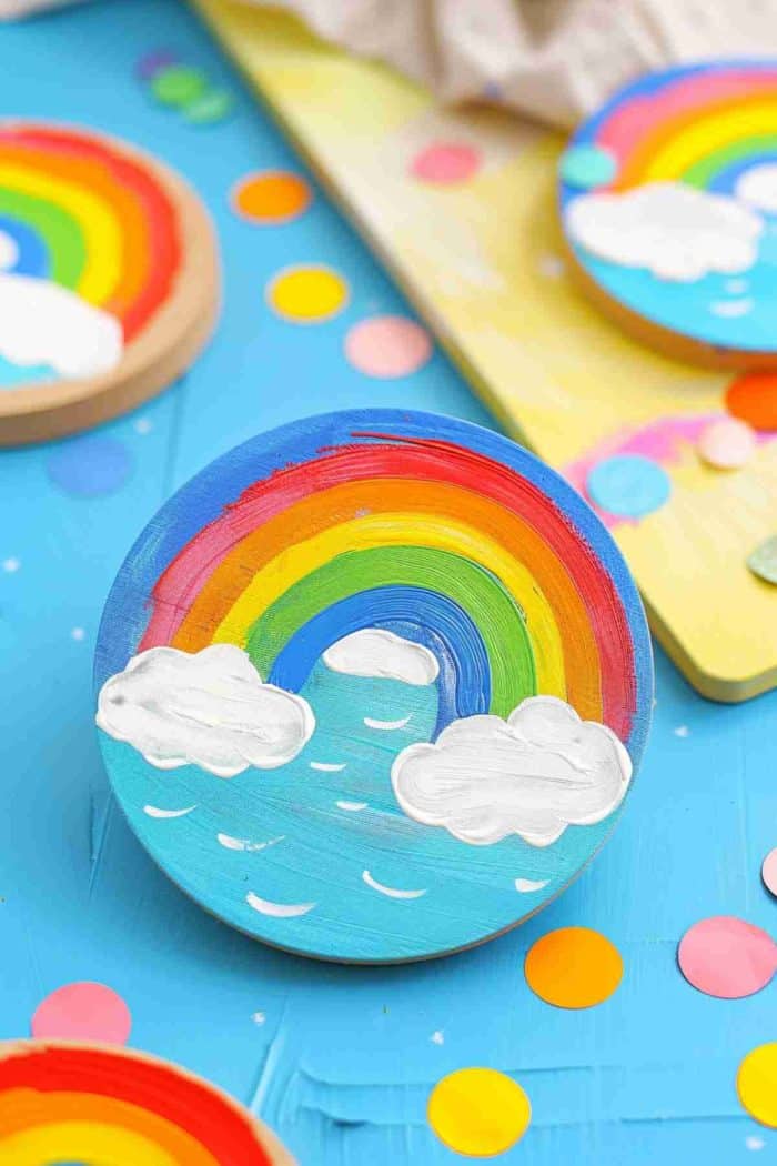 Create coasters with bright rainbows and fluffy clouds, symbolizing hope and positivity.