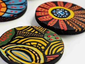 Coasters are adorned with hand-painted tribal patterns, featuring dynamic shapes and vivid colors that celebrate cultural artistry. These designs can add an eclectic and energetic vibe to any setting.