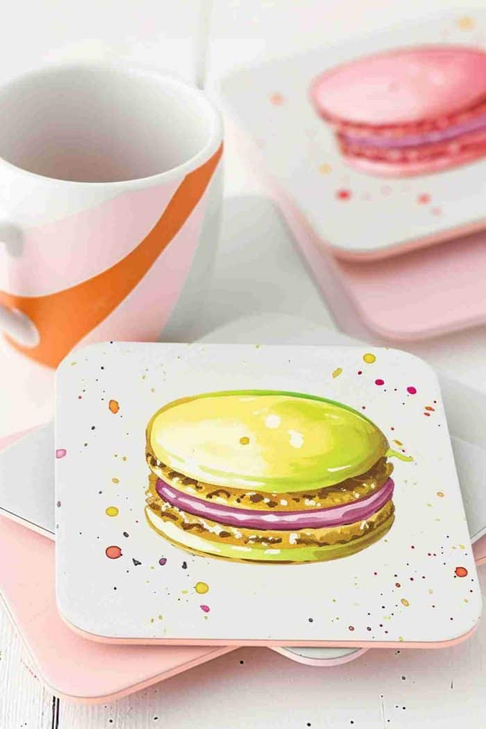 Depict a lineup of delicate macarons in soft pastel hues on coasters, capturing the essence of these French confections.