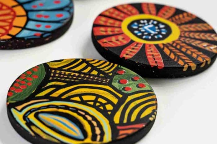 Coasters are adorned with hand-painted tribal patterns, featuring dynamic shapes and vivid colors that celebrate cultural artistry. These designs can add an eclectic and energetic vibe to any setting.