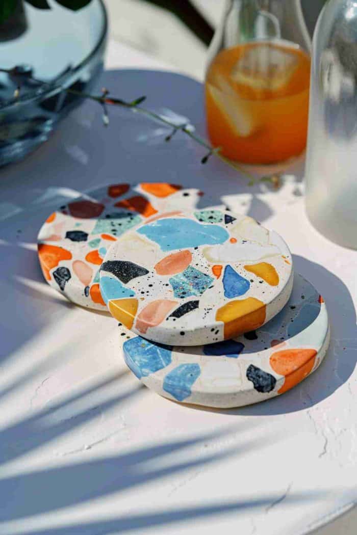 Emulate the terrazzo look by painting colorful, irregular flecks on a white background. This modern interpretation of terrazzo brings a trendy and artistic flair to the traditional drink coaster.
