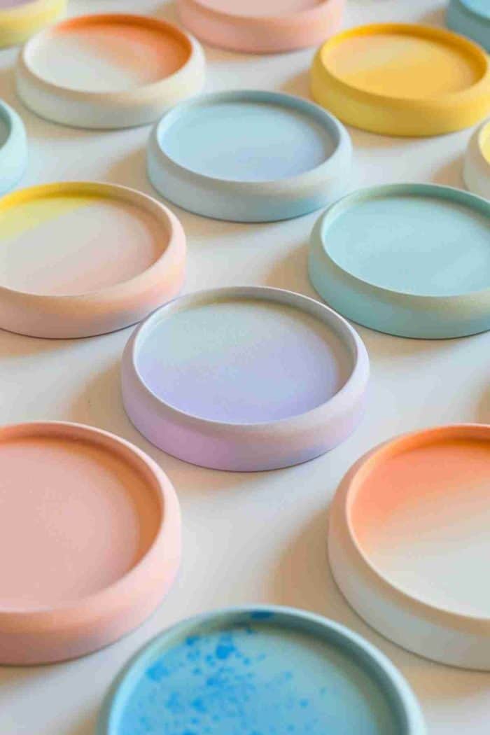 Blend pastel paints to achieve a soft, ombre effect on coasters, transitioning from one color to another. This soothing color gradient can complement any home decor with its subtle charm.