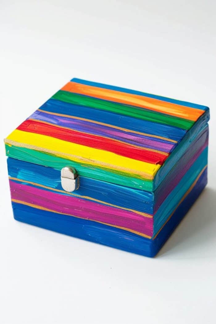 Brighten a jewelry box with hand-painted rainbow stripes, each color applied side by side in vibrant bands. 