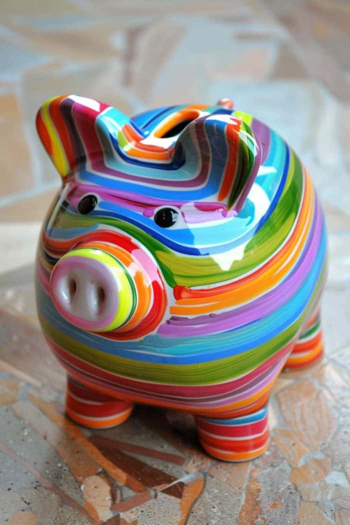 Bold and bright, this piggy bank is a kaleidoscope of color with its horizontal rainbow stripes and glossy finish.