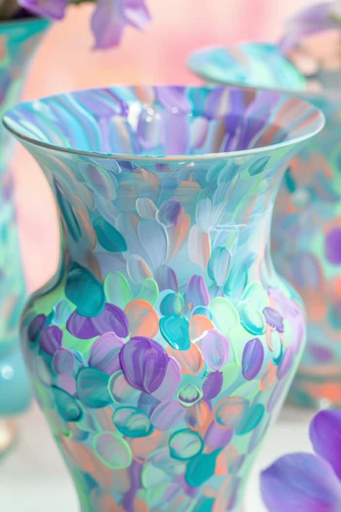 The vase glistens with a spectrum of pearlescent paints that mimic the light-reflecting scales of a mermaid's tail. 