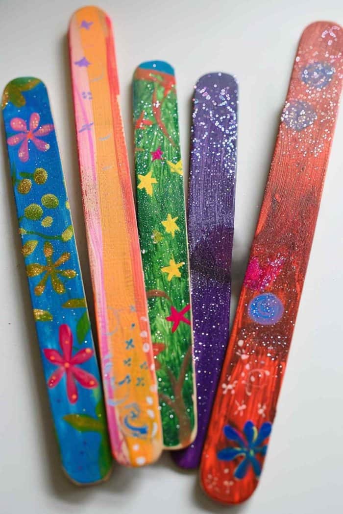 Craft decorative bookmarks using popsicle sticks. Paint and decorate each stick with unique designs, such as glitter, stickers, or small drawings. 