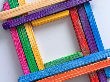 Craft a picture frame by carefully aligning popsicle sticks for the edges. Glue the sticks together to form a square or rectangle, then decorate with paint, stickers, or glitter. 
