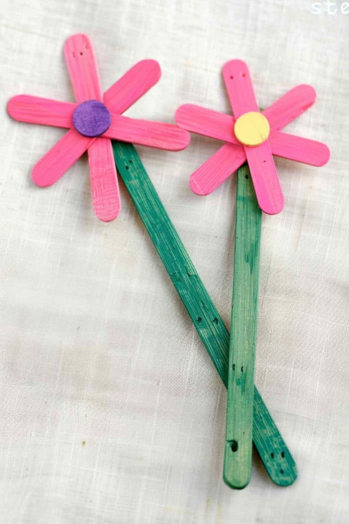 Make a flower out of popsicle sticks. Use one stick for the stem and five small ones for the petals. Paint the “stem” stick green and the five sticks pink, blue, or purple for an adorable craft.