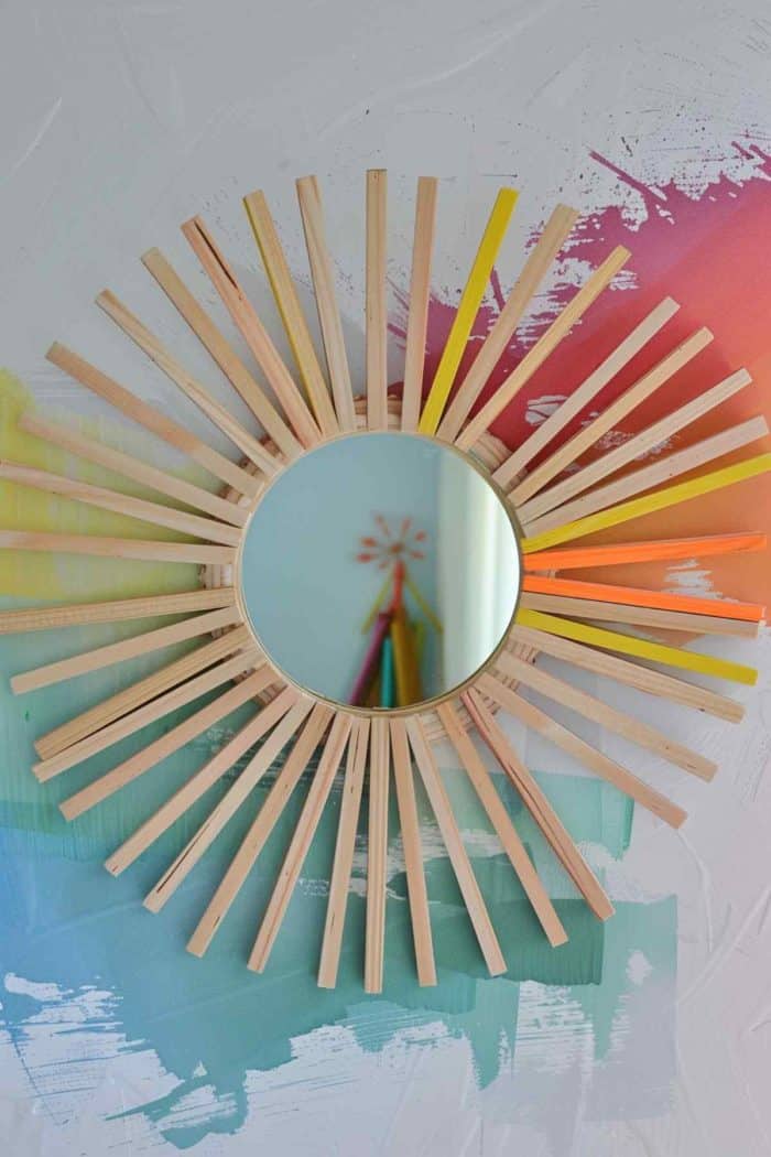 Make a sunburst mirror using popsicle sticks. Cut off the rounded ends, then glue the sticks in a radiating pattern around a small mirror, creating a sunburst effect. 