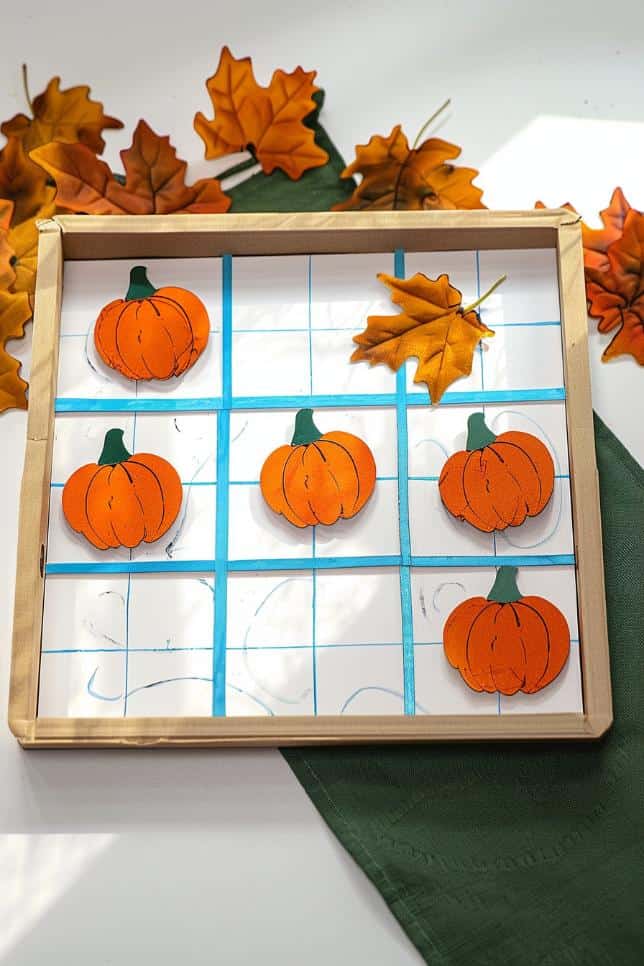 Create a tic-tac-toe board on a small square of wood or heavy cardboard, drawing a grid and painting it to resemble a pumpkin patch.