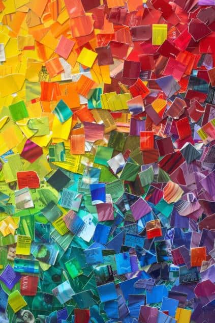 Cut out blocks of color from old colored boxes and arrange them on a canvas or heavy paper to form a rainbow pattern. 