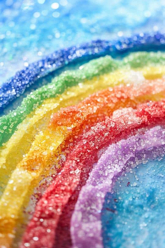 Draw a rainbow design with glue on thick paper, then sprinkle different colors of salt over each section. 