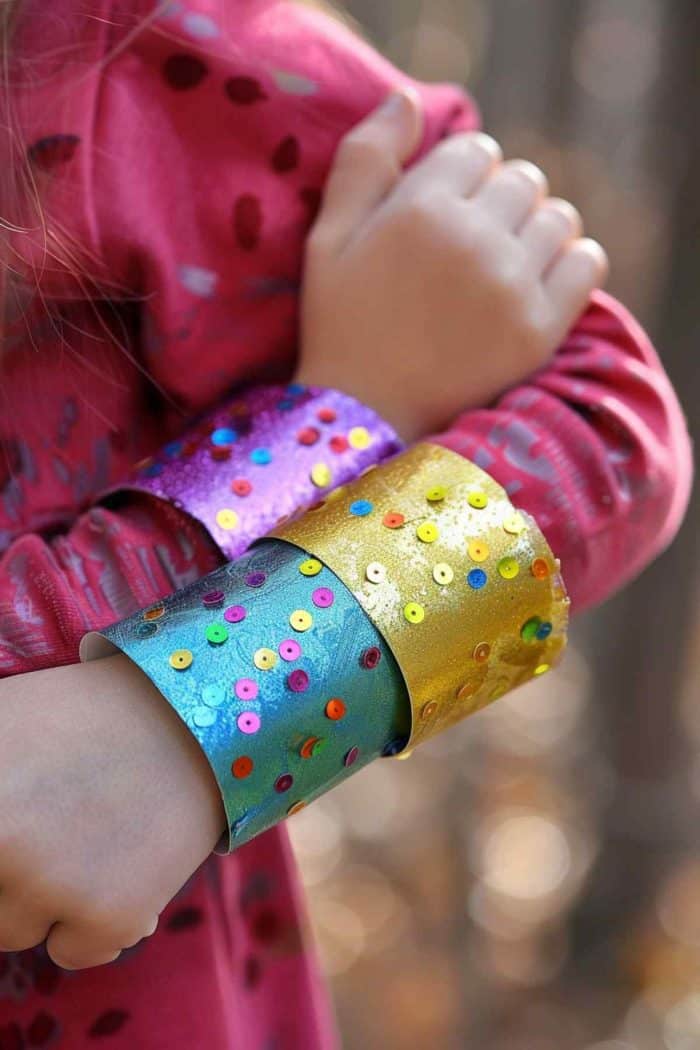 Create dazzling superhero cuffs by covering jumbo toilet paper rolls with shiny foil or metallic paint. Embellish them with glitter and sequins to add sparkle. 