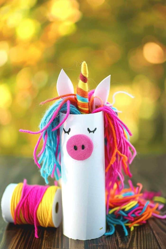 Make unicorns by painting toilet paper rolls white and gluing yarn around the top for the mane, choosing pastel or rainbow colors. 