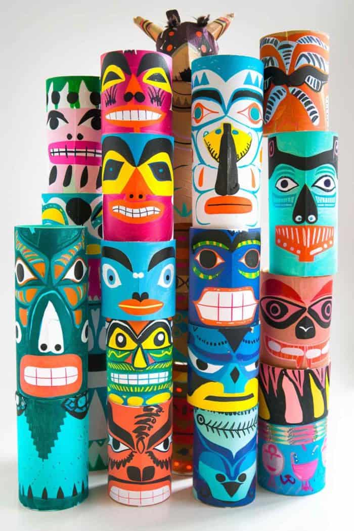 Create totem poles by stacking multiple toilet paper rolls vertically and securing them together. 