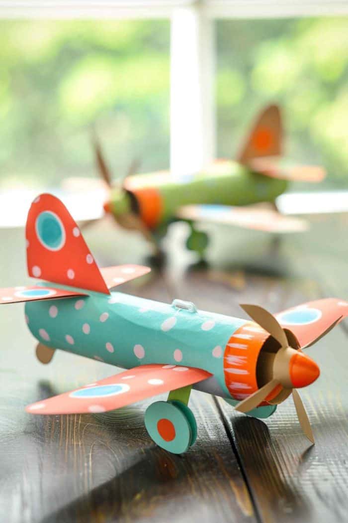 Craft airplanes by cutting wing flaps from cardstock and attaching them to toilet paper rolls painted in bright hues or covered in colored paper. 