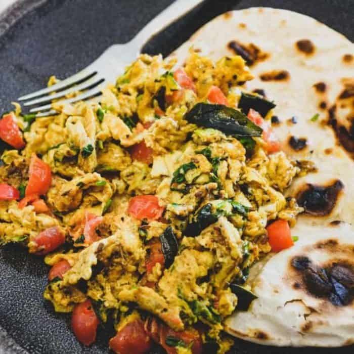 This Parsi dish is a soft, spicy tumble of eggs cooked with fragrant cilantro, tomatoes, and a generous helping of spices. 