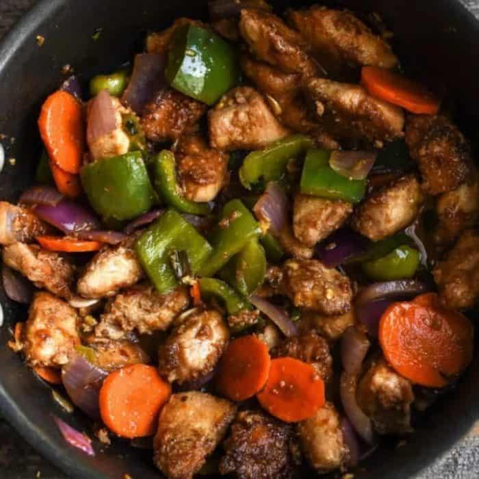 In this recipe, marinated pieces of chicken breast are fried to a sizzle and then draped in a fiery red sauce with bold flavors of garlic, ginger, and green chilies. 