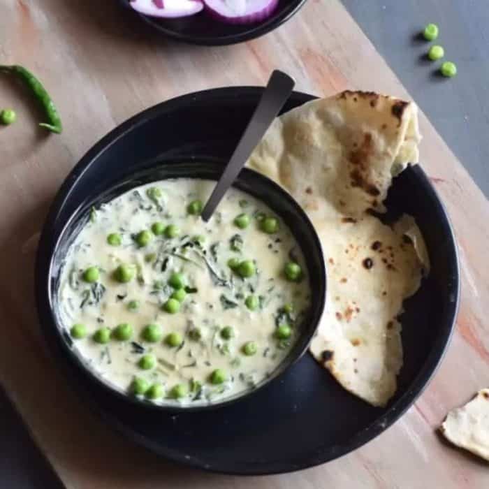 This delicate curry boasts a smooth, creamy sauce that combines the slightly bitter notes of fenugreek leaves (methi) and sweet green peas, creating a harmonious blend of contrasting flavors often relished with a side of fluffy naan.