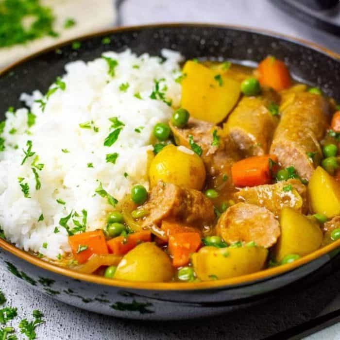 Each sausage in this dish is browned to perfection and then slow-cooked to tender succulence with fragrant curry spices, hearty chunks of carrot, and comforting potatoes. 