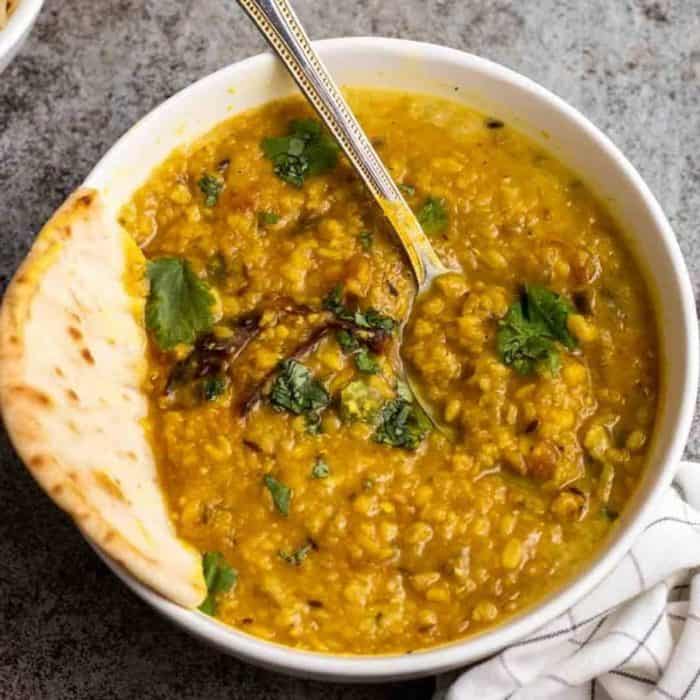 Moong and masoor (split red lentils and split mung beans) come together in this dish for a humble yet hearty affair, elevated by a simmer with aromatic spices, tomatoes, red onions, garlic, ginger, and dried chilies. 